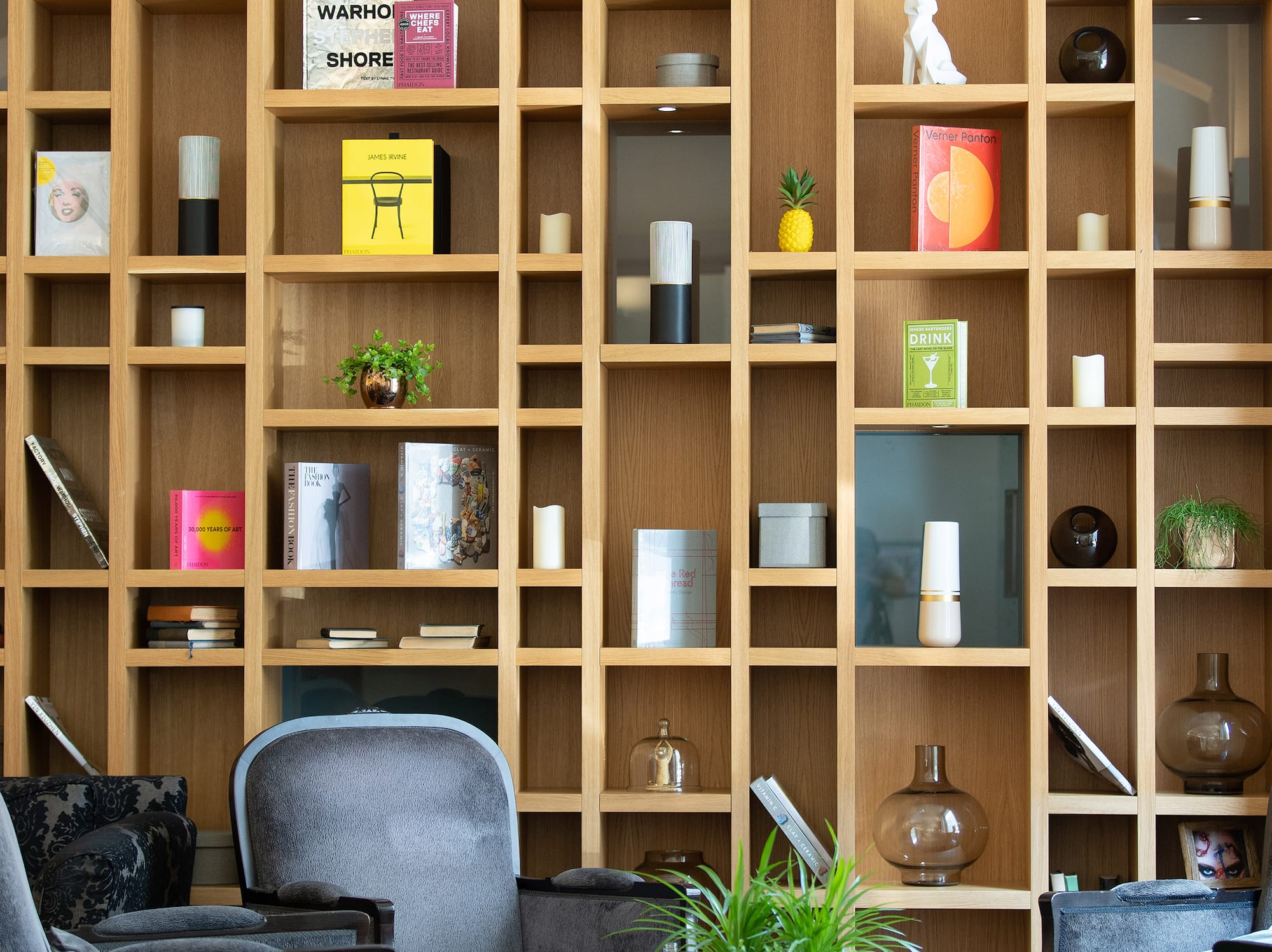 a room with shelves and chairs