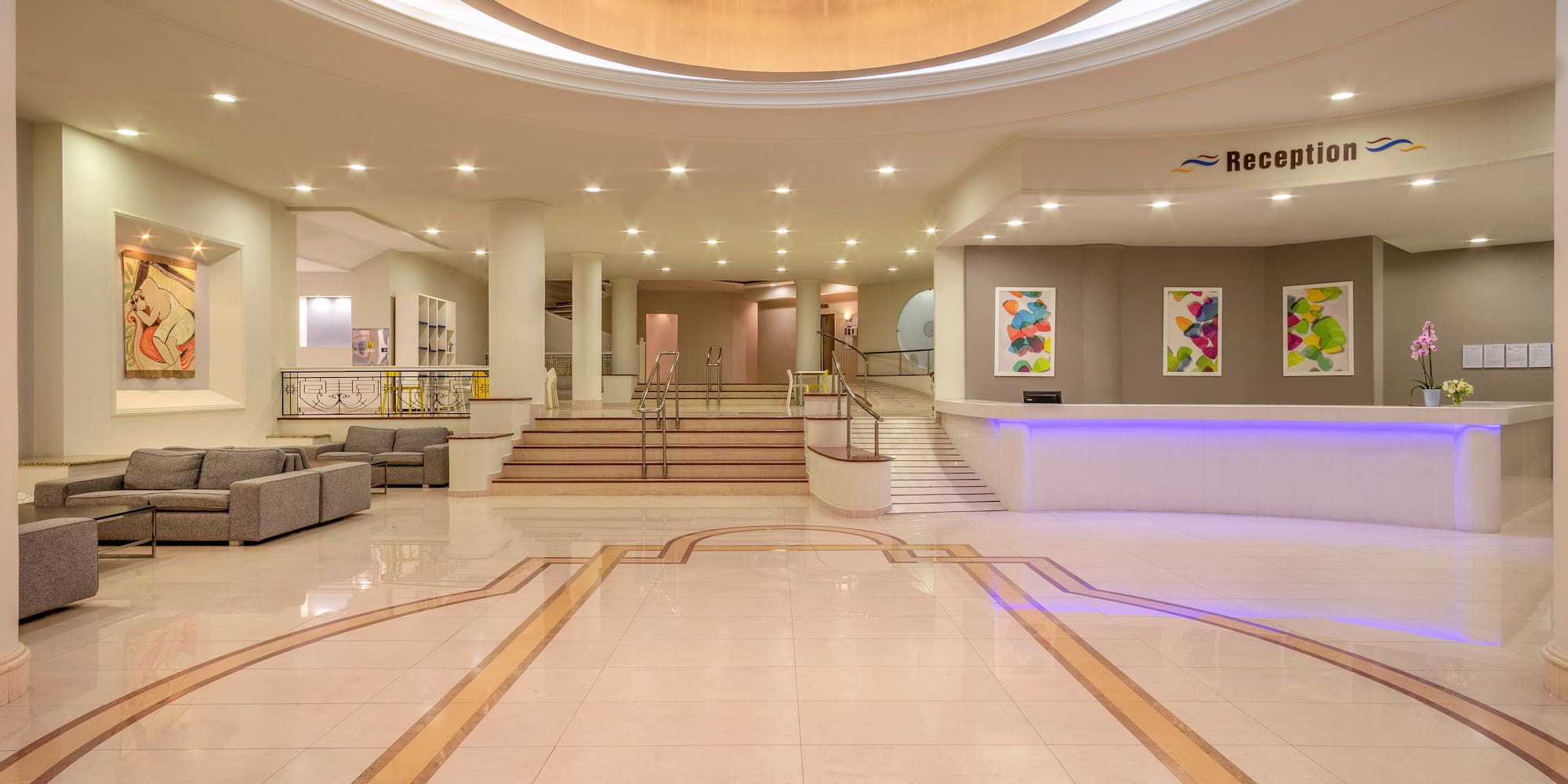 a large lobby with a large ceiling and stairs