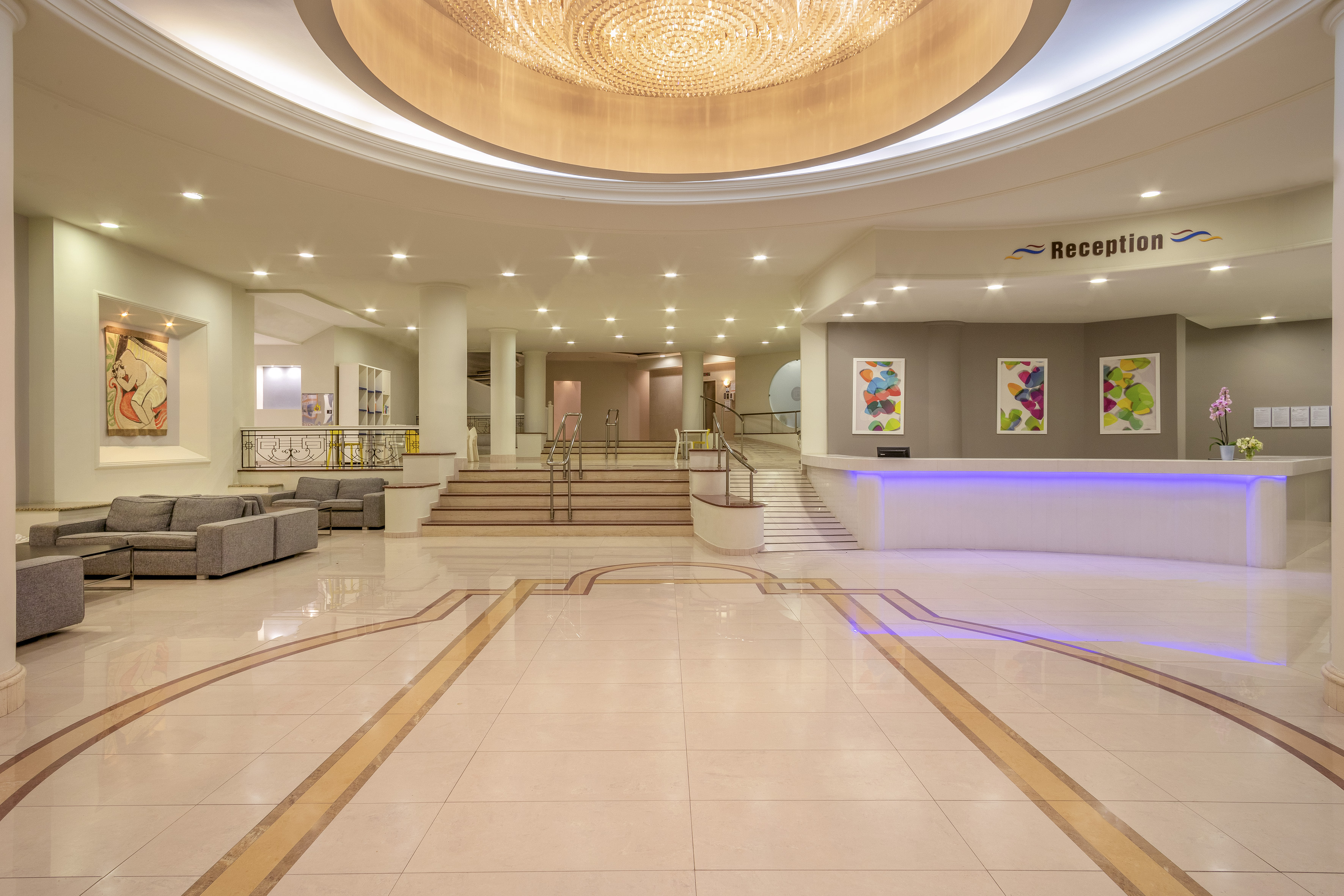 a large lobby with a large ceiling and stairs