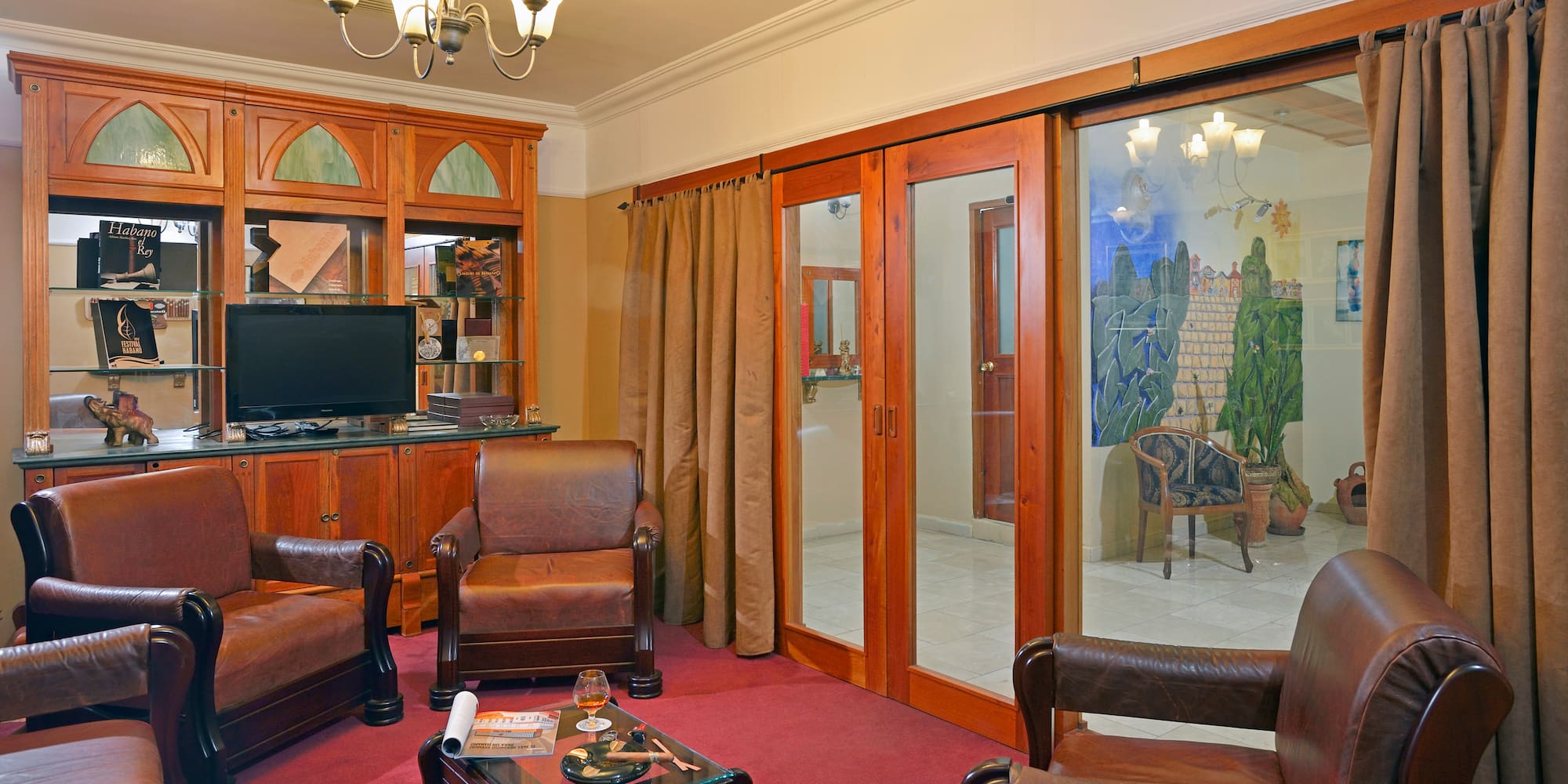 a room with a television and chairs