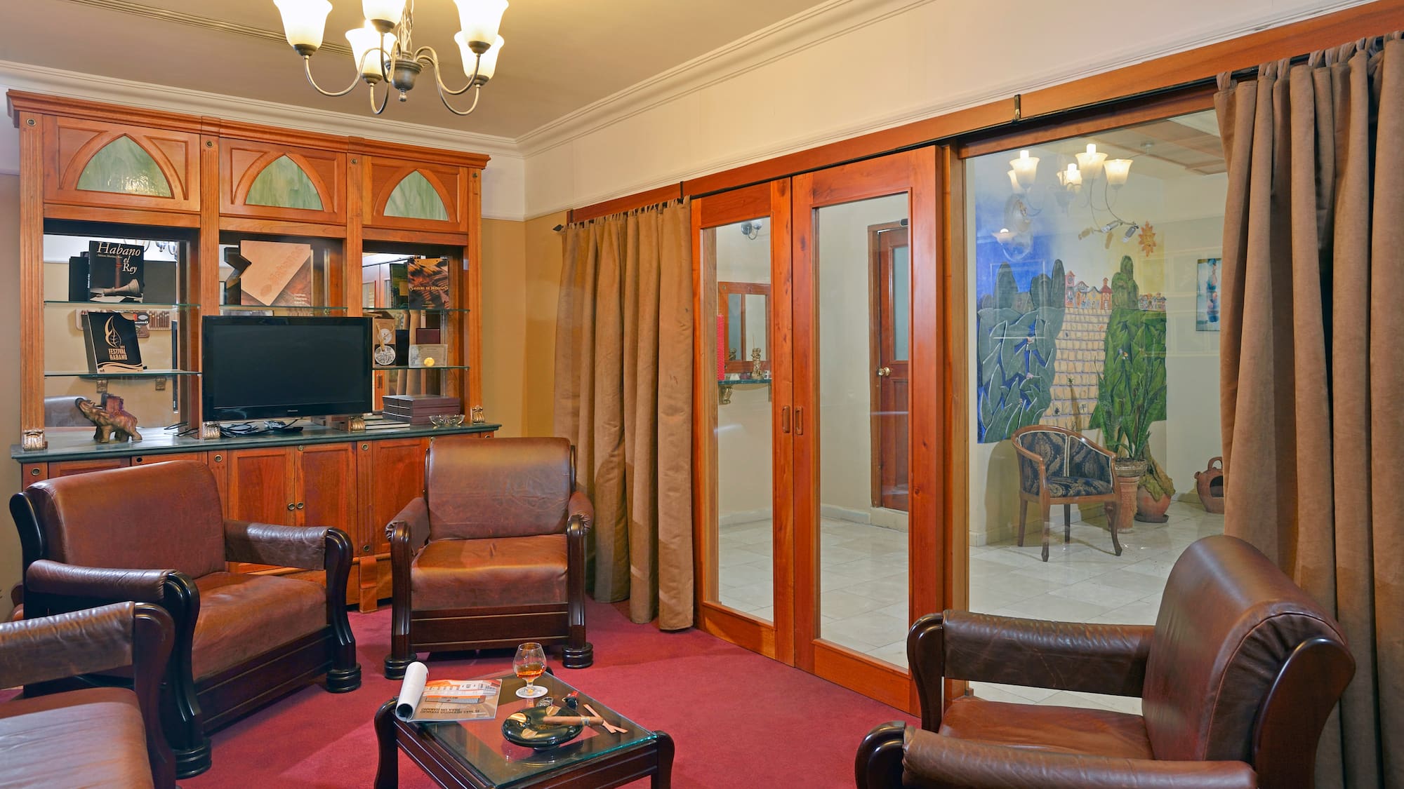 a room with a television and chairs