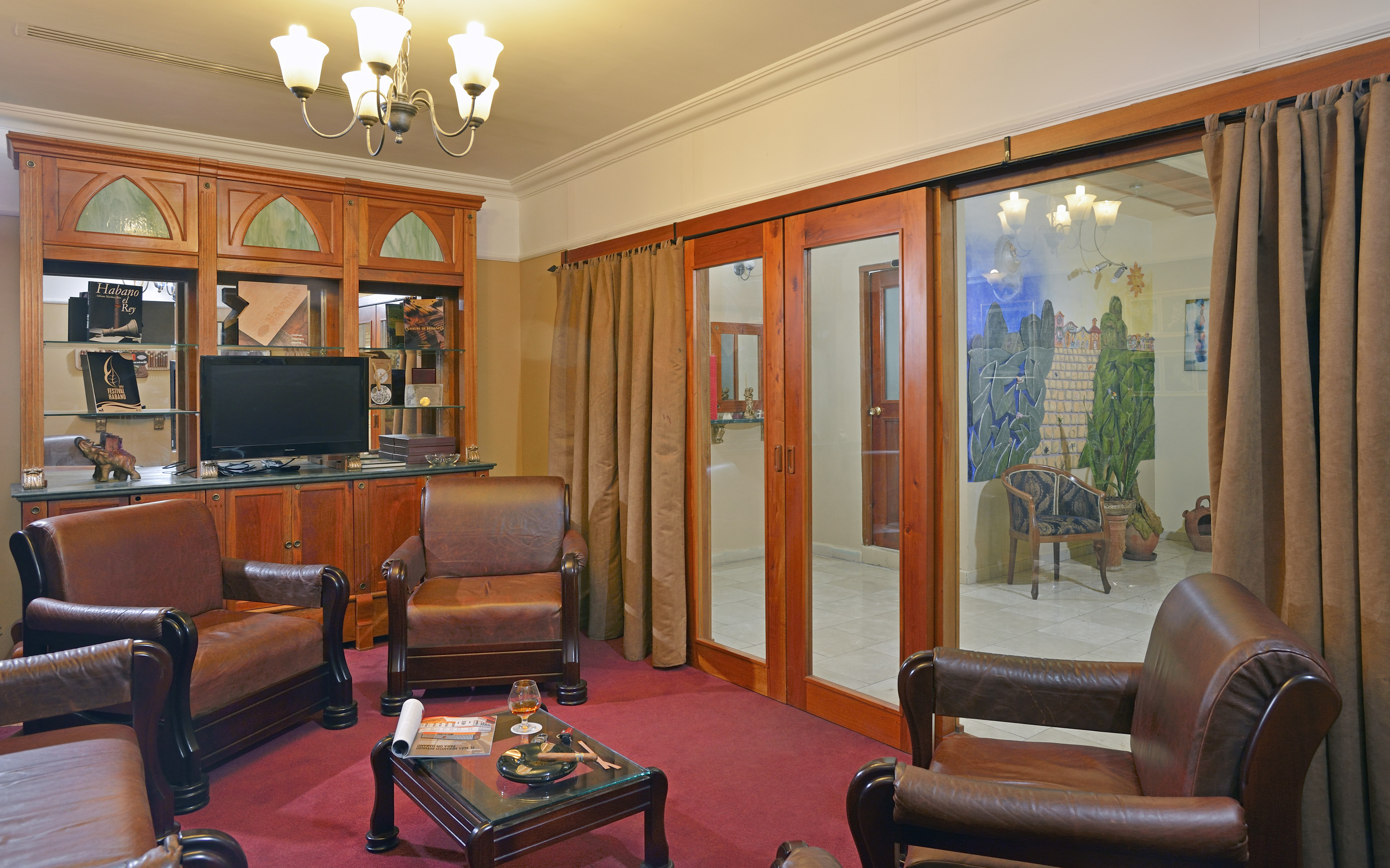 a room with a television and chairs