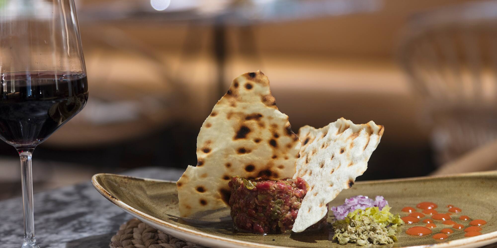 a plate of food and a glass of wine