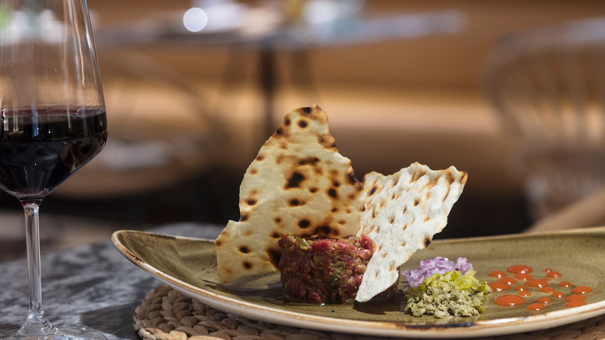 a plate of food and a glass of wine