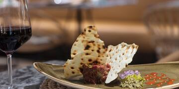 a plate of food and a glass of wine