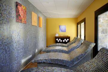 a room with a tiled wall and chairs