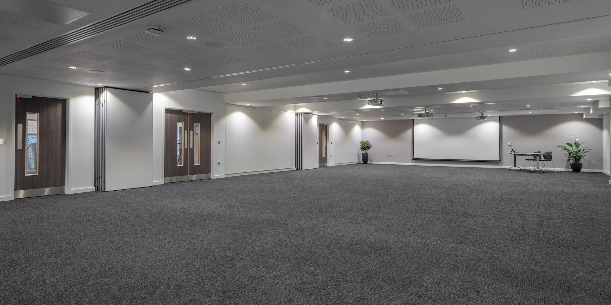 a large room with a white screen and a white screen