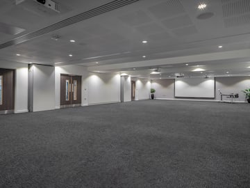 a large room with a white screen and a white screen