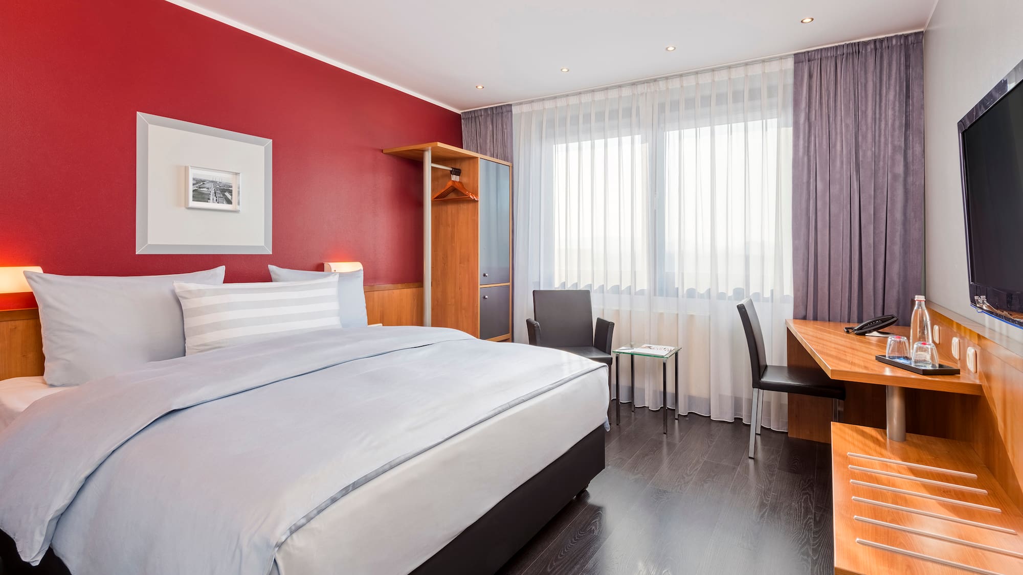 a bedroom with a desk and a bed