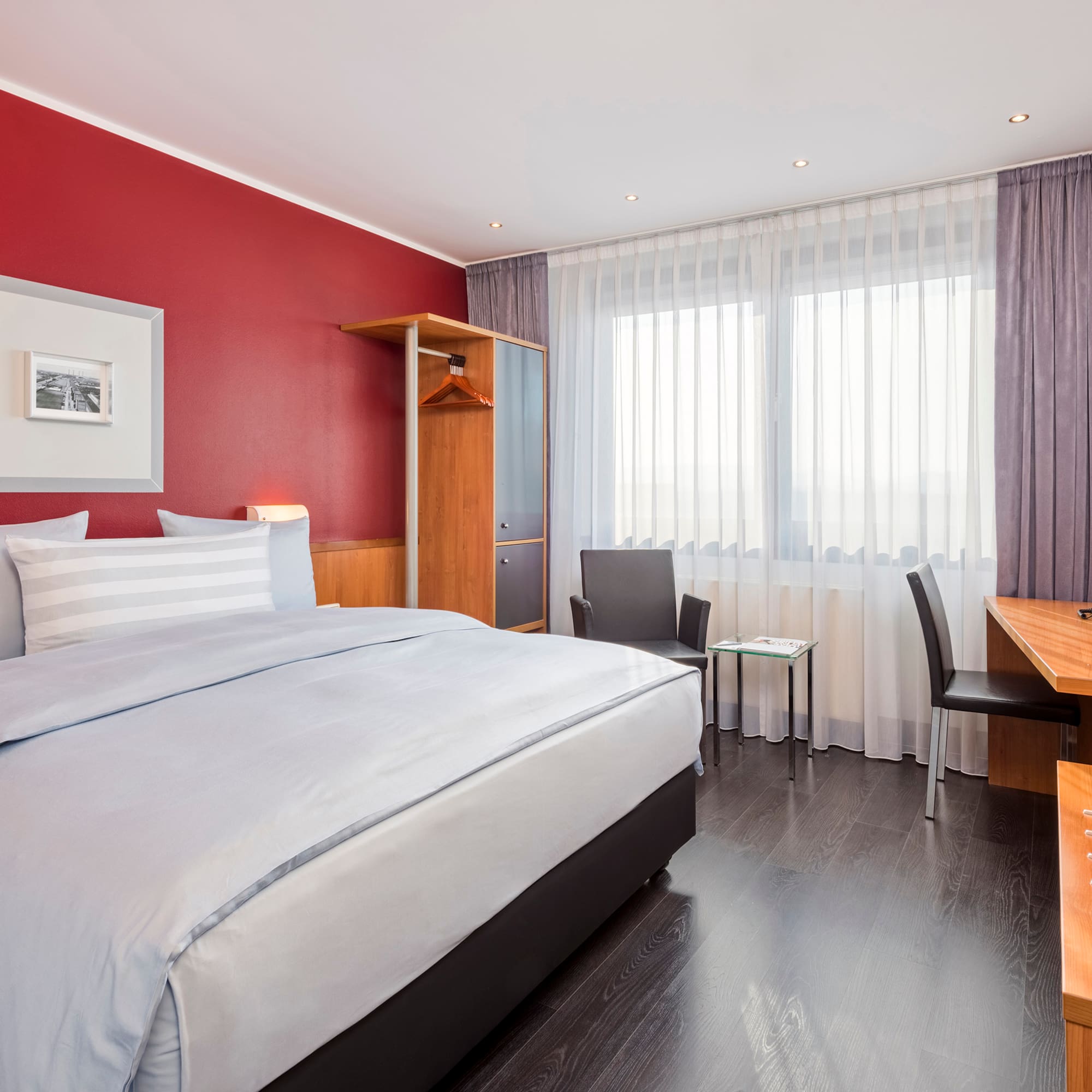 a bedroom with a desk and a bed