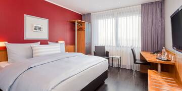 a bedroom with a desk and a bed