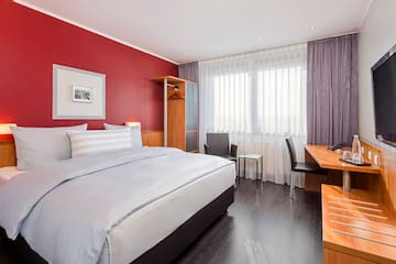 a bedroom with a desk and a bed