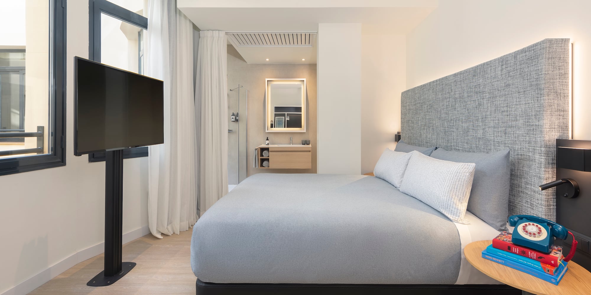 a bedroom with a bed and a tv