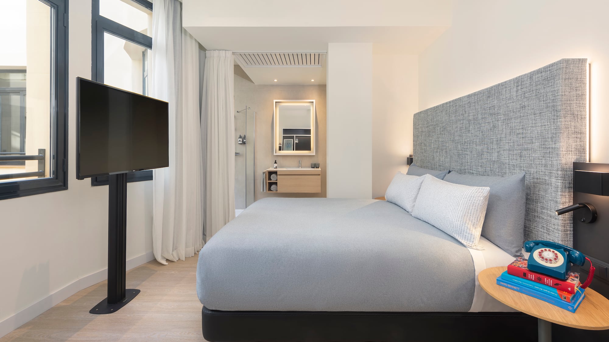 a bedroom with a bed and a tv