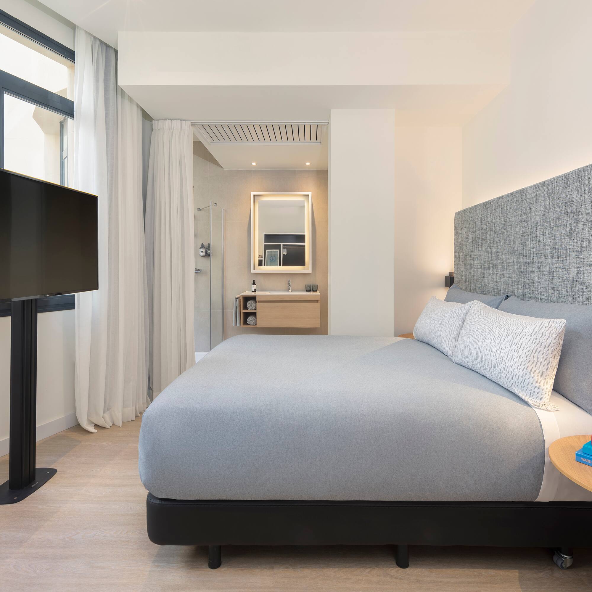 a bedroom with a bed and a tv