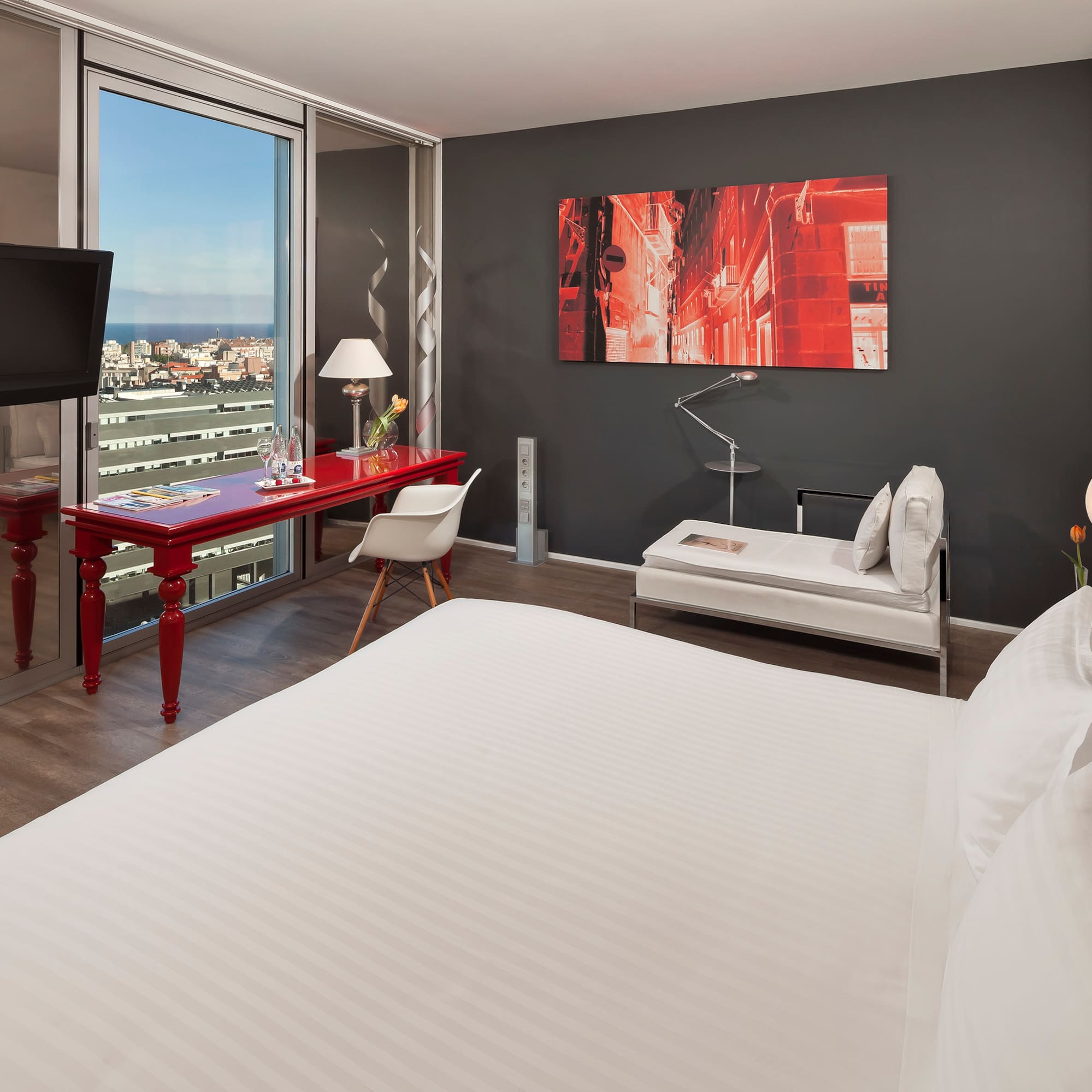 a room with a bed and a television