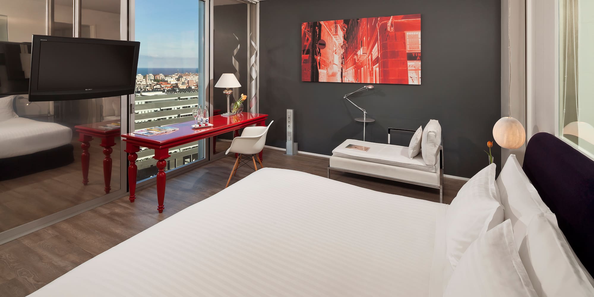 a room with a bed and a television