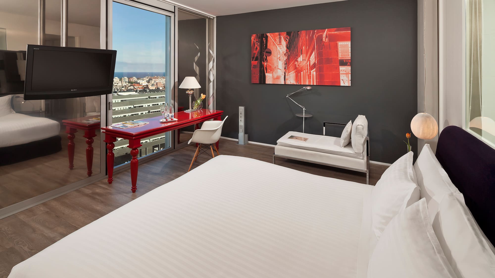 a room with a bed and a television