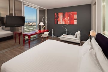a room with a bed and a television