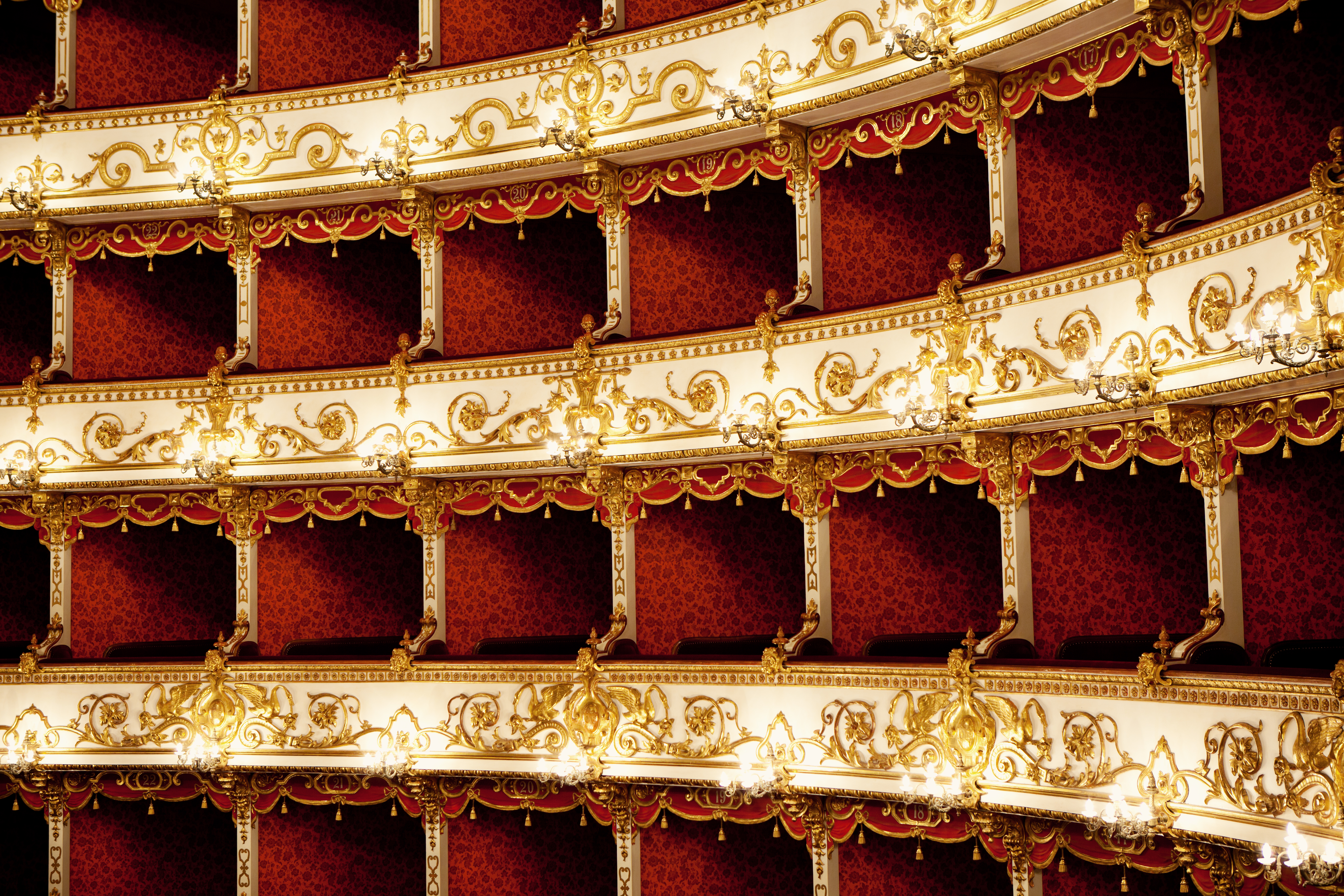 a red and white theater with gold designs