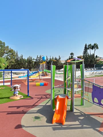 a playground with a slide and a playground equipment