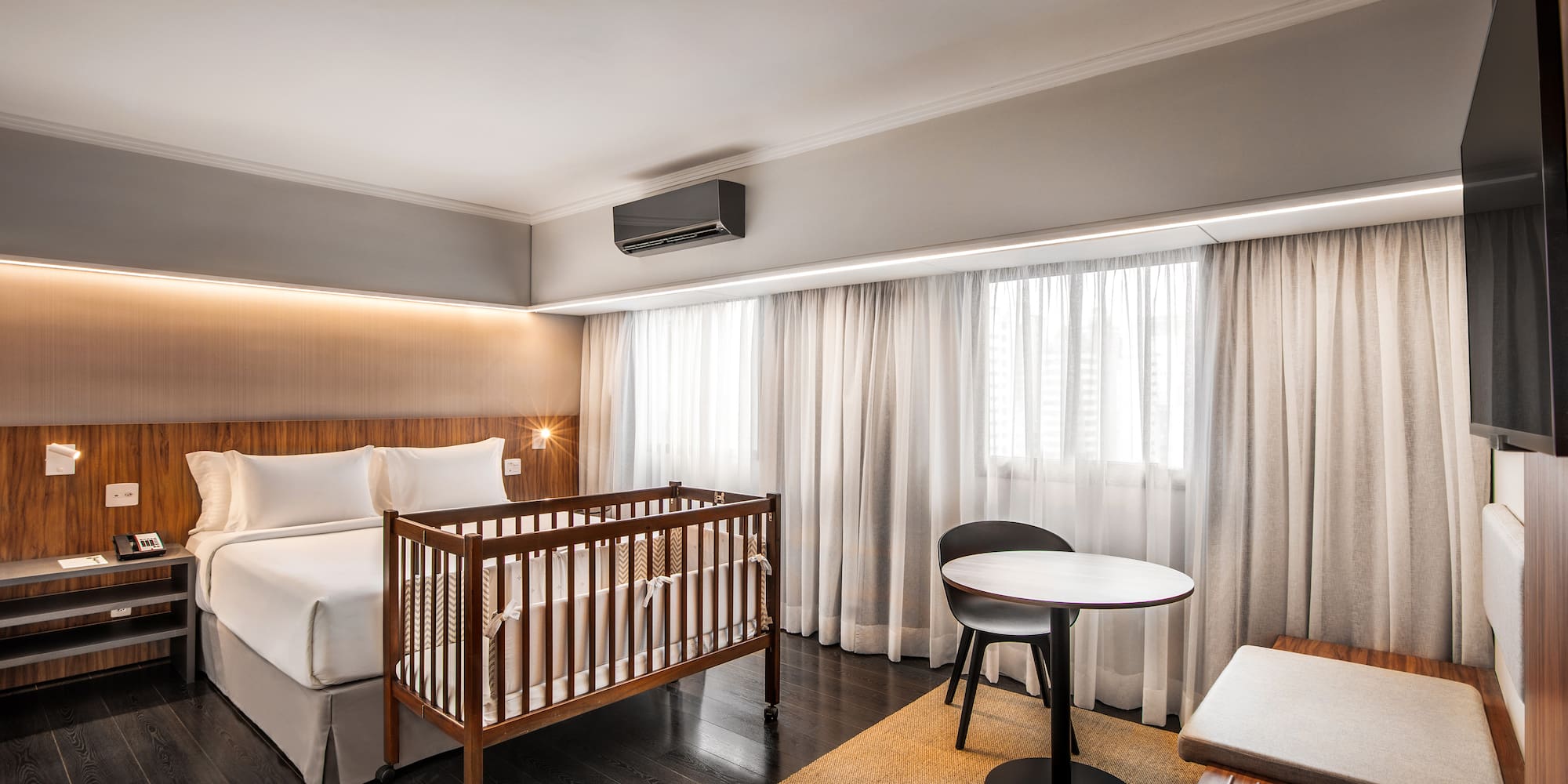 a room with a crib and a table