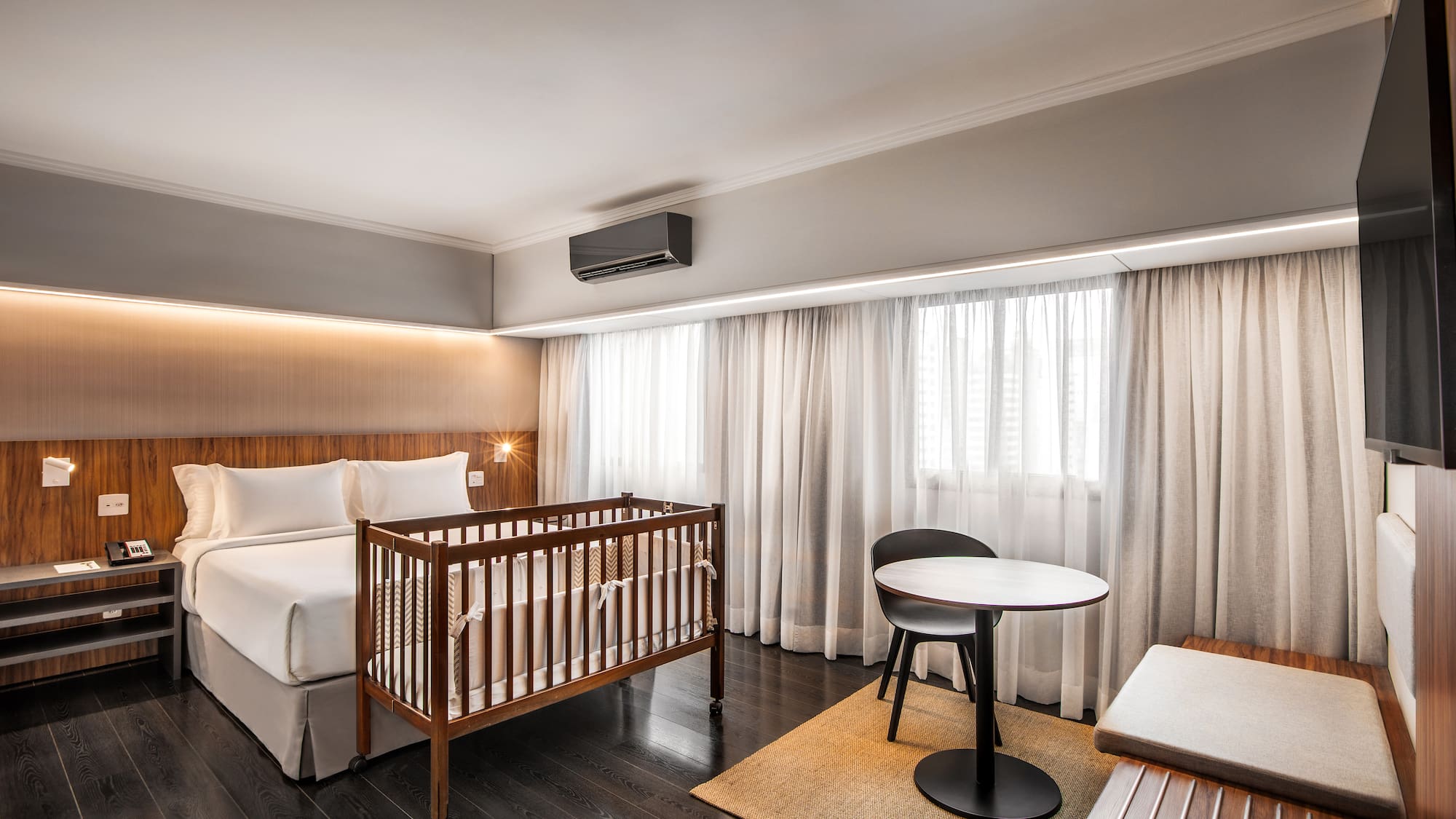 a room with a crib and a table