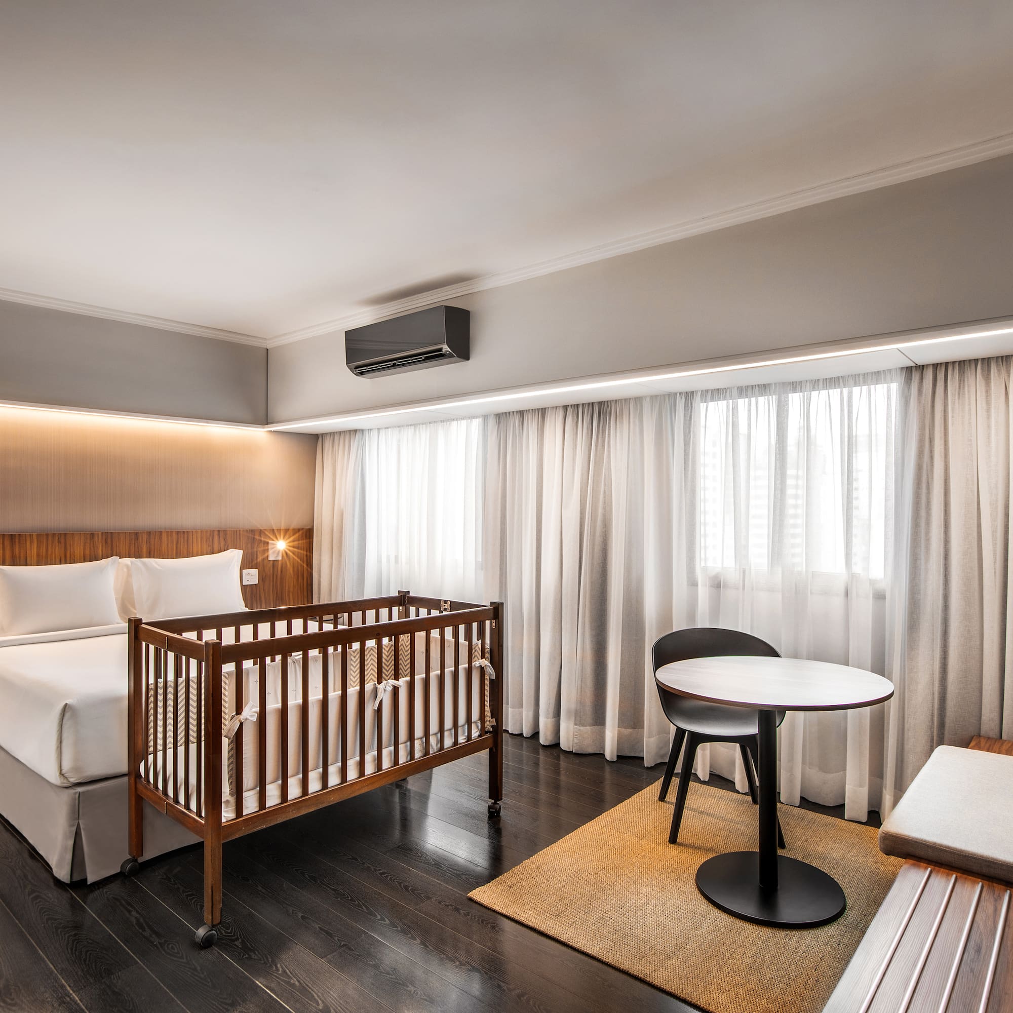 a room with a crib and a table