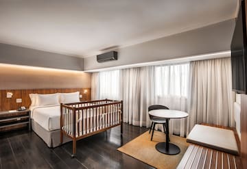 a room with a crib and a table