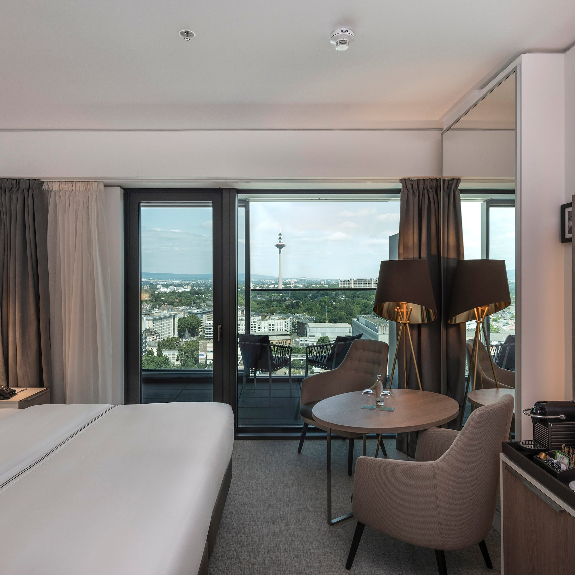 a room with a bed and a table and chairs