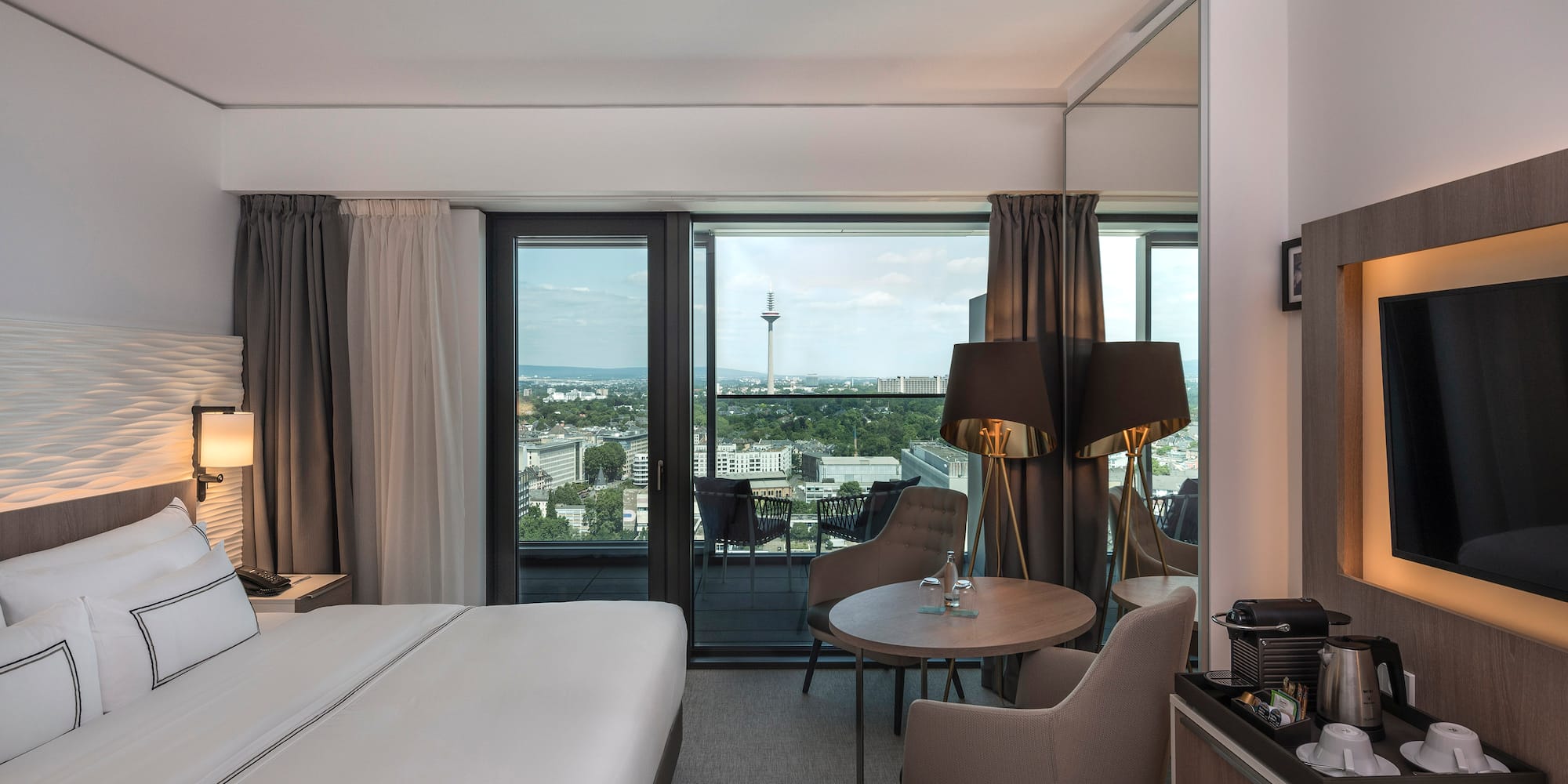 a room with a bed and a table and chairs