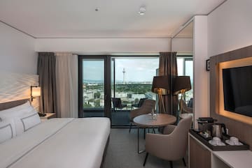 a room with a bed and a table and chairs