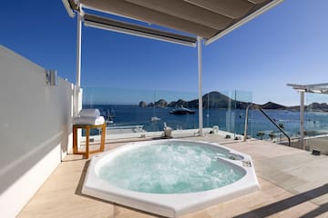 a hot tub on a deck overlooking the ocean
