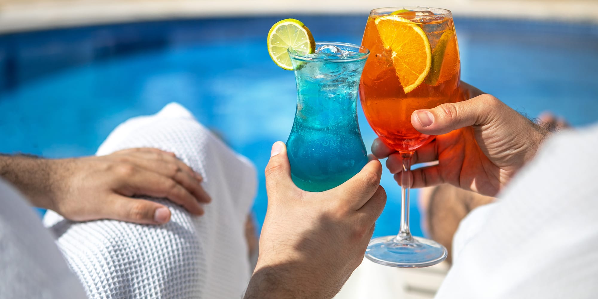 a pair of hands holding drinks