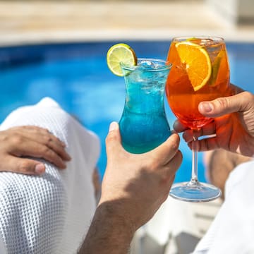 a pair of hands holding drinks