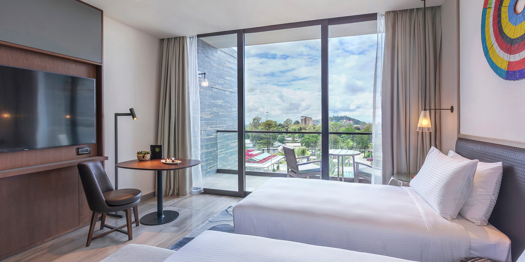 a room with two beds and a table and chairs