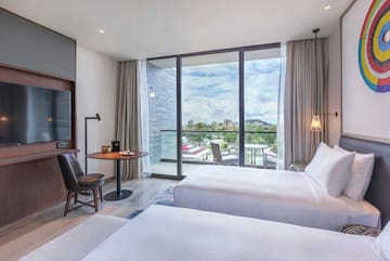 a room with two beds and a table and chairs