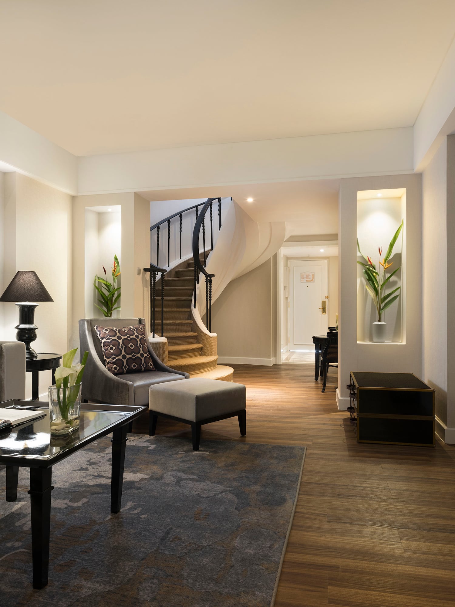 a living room with a spiral staircase