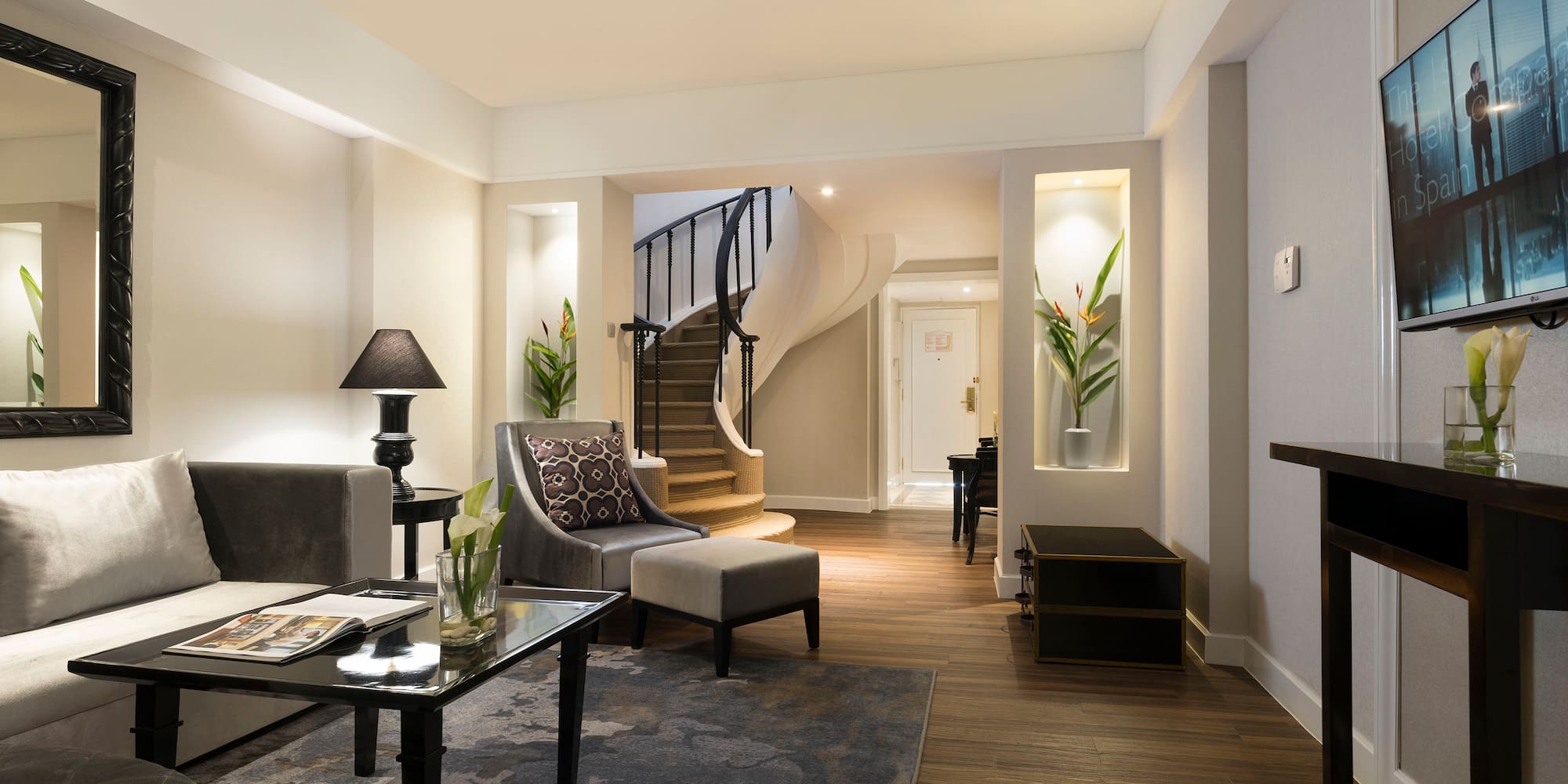 a living room with a spiral staircase