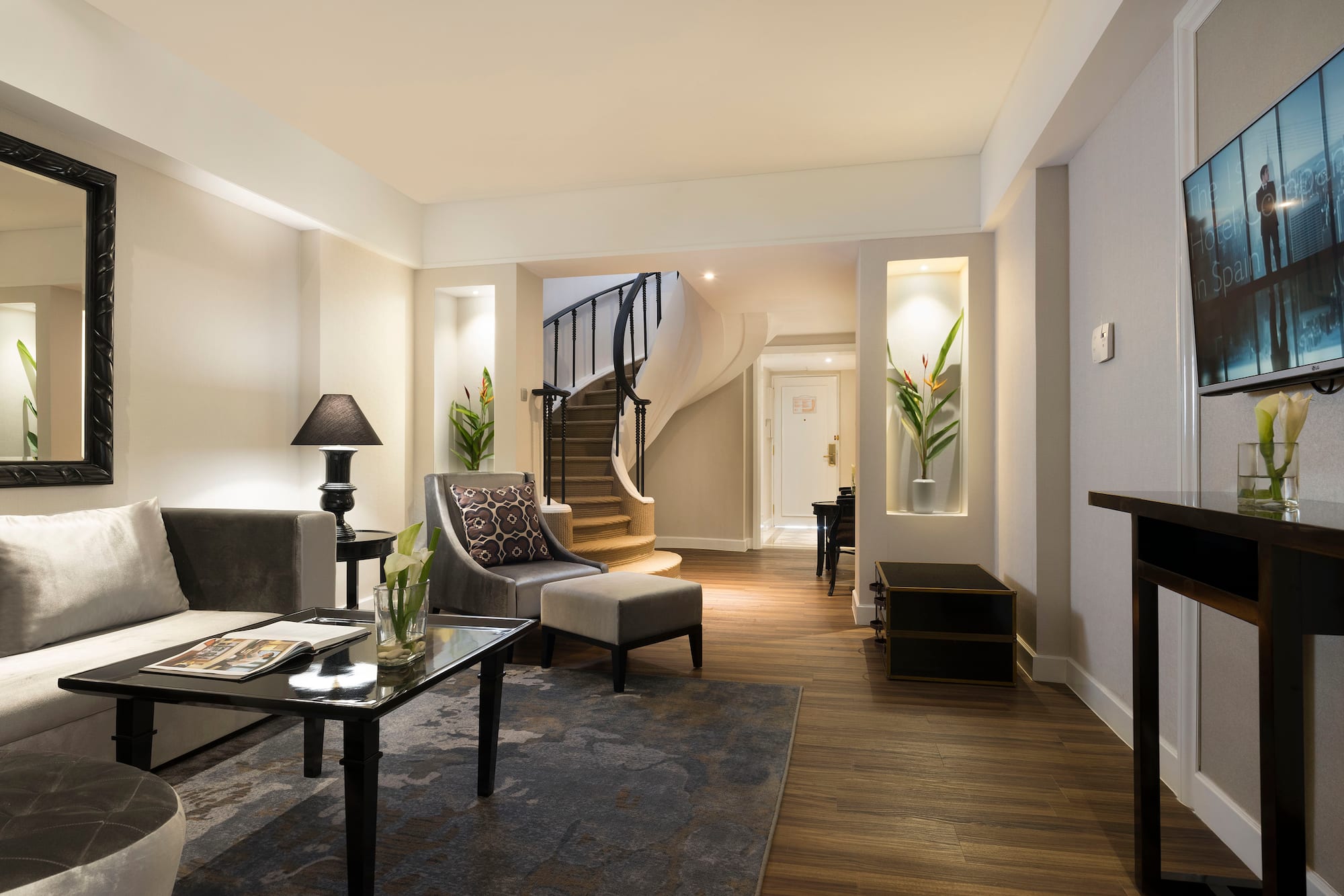 a living room with a spiral staircase