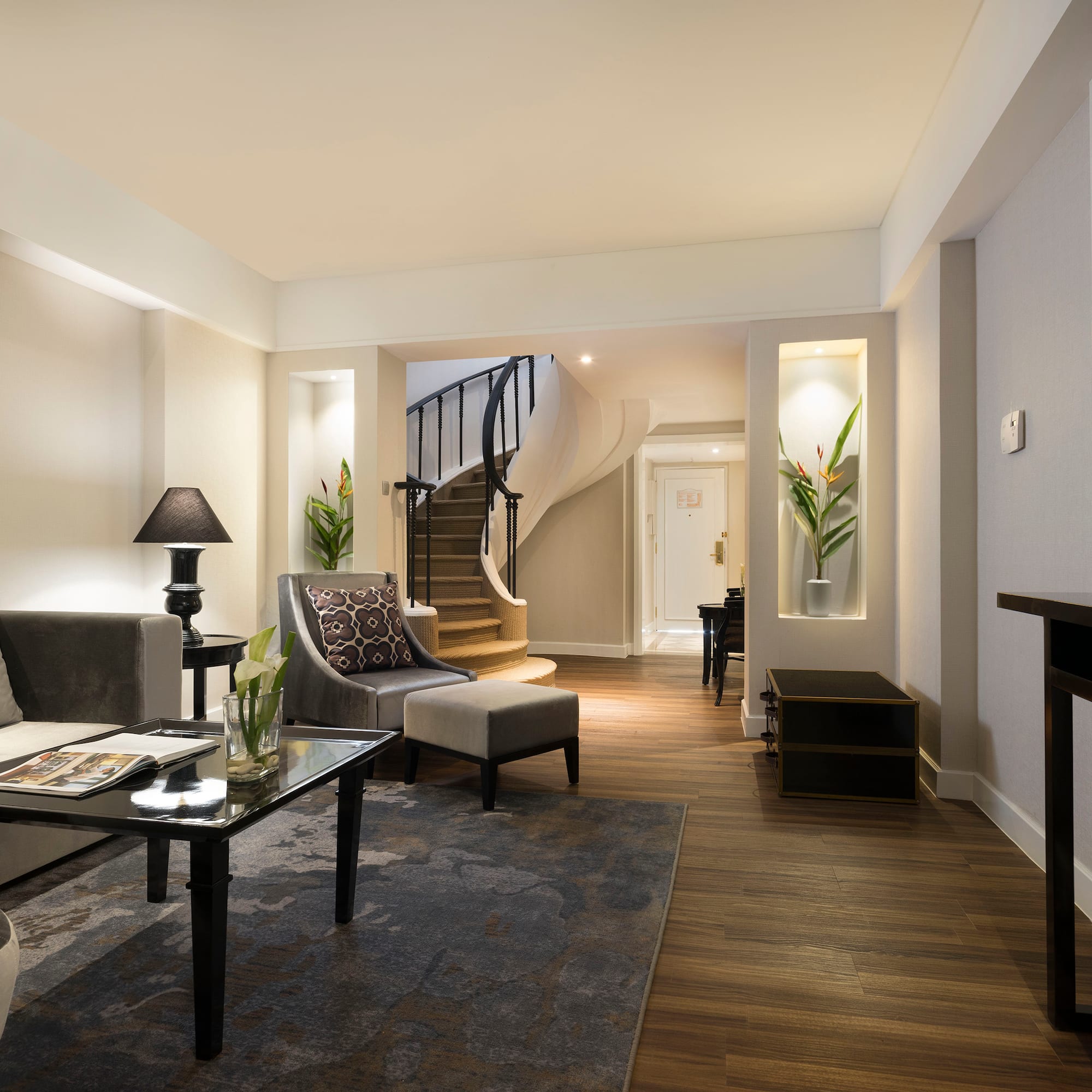 a living room with a spiral staircase