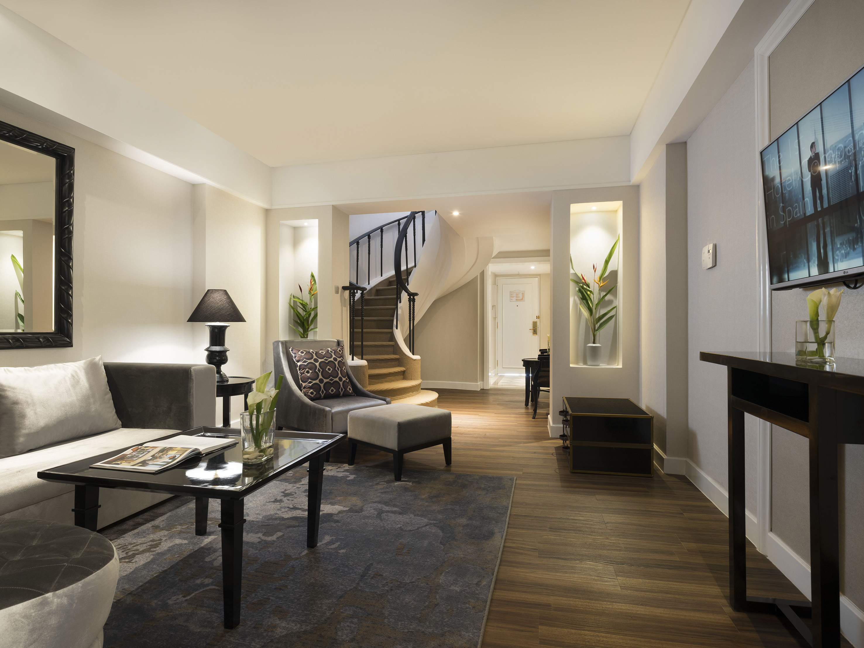 a living room with a spiral staircase