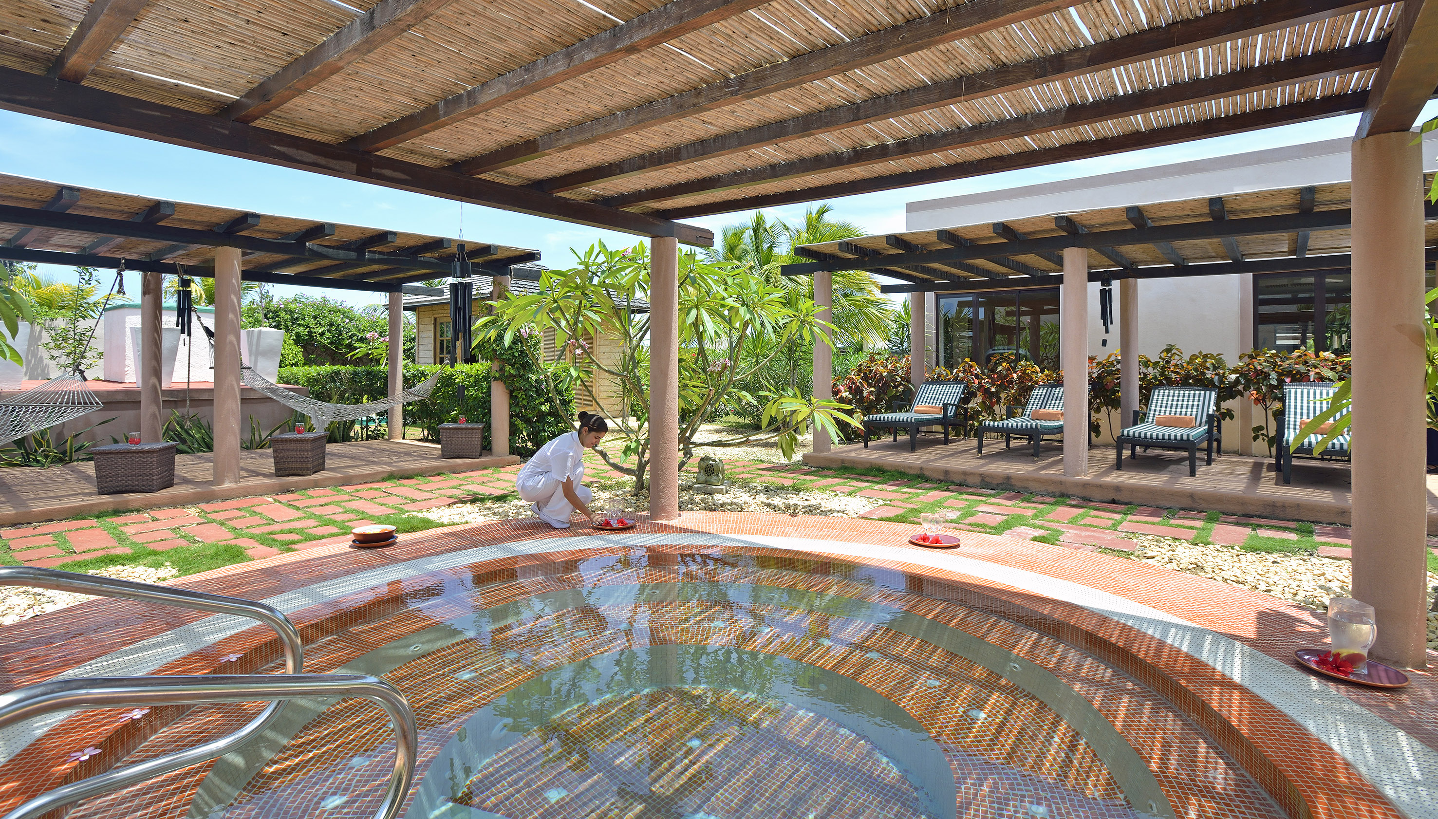a woman cleaning a hot tub outside
