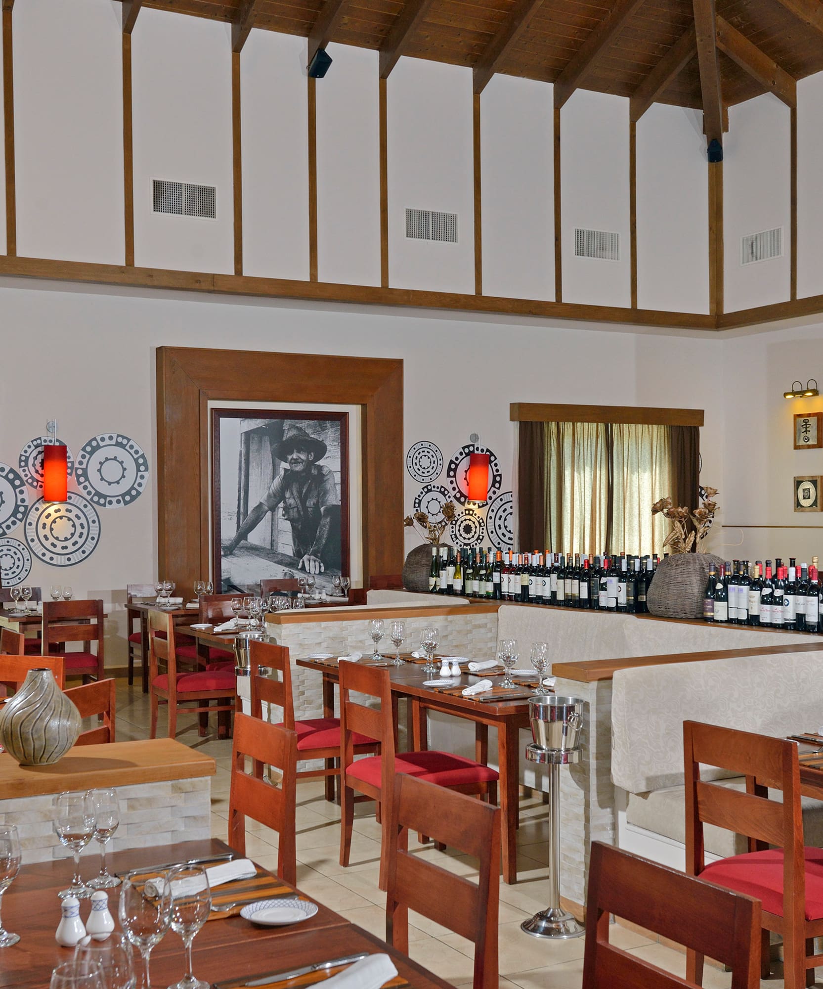 a room with tables and chairs and wine bottles
