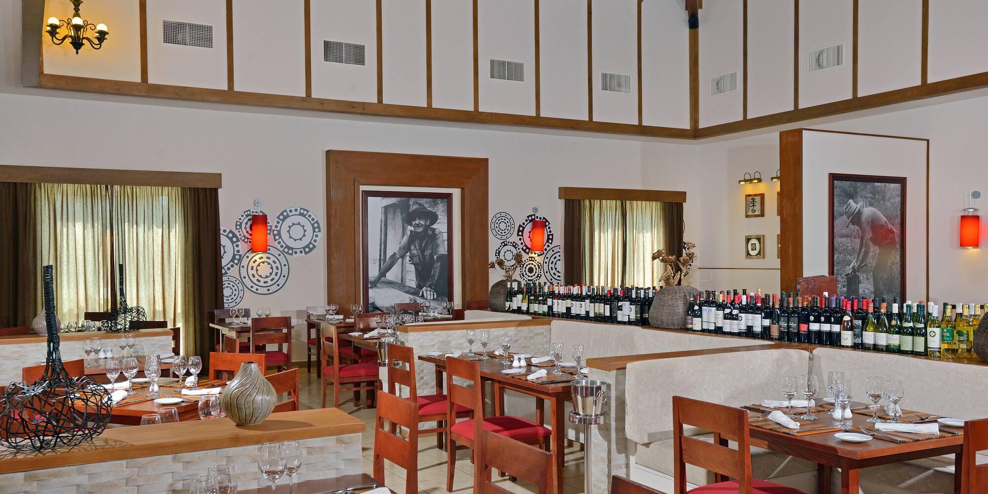 a room with tables and chairs and wine bottles