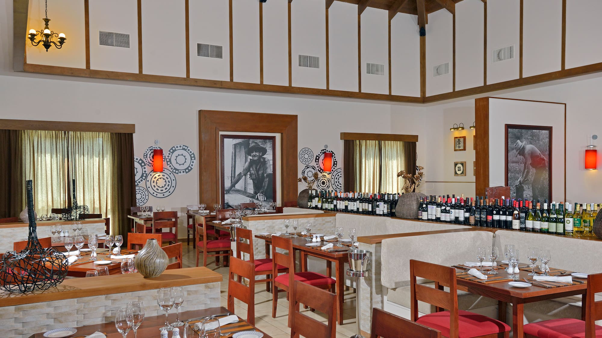a room with tables and chairs and wine bottles