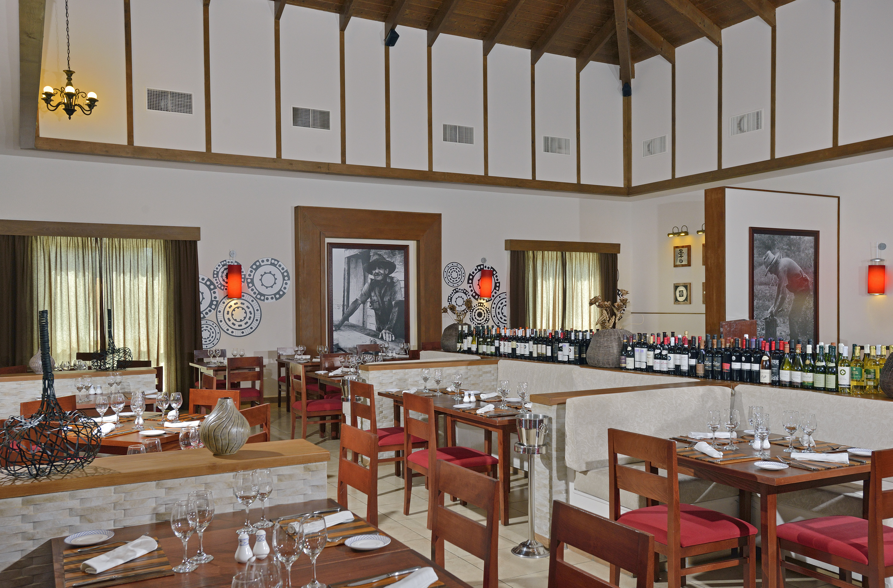 a room with tables and chairs and wine bottles