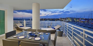 a table set up on a deck overlooking a body of water
