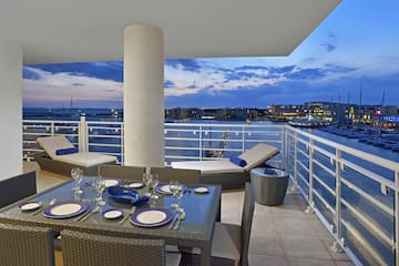 a table set up on a deck overlooking a body of water