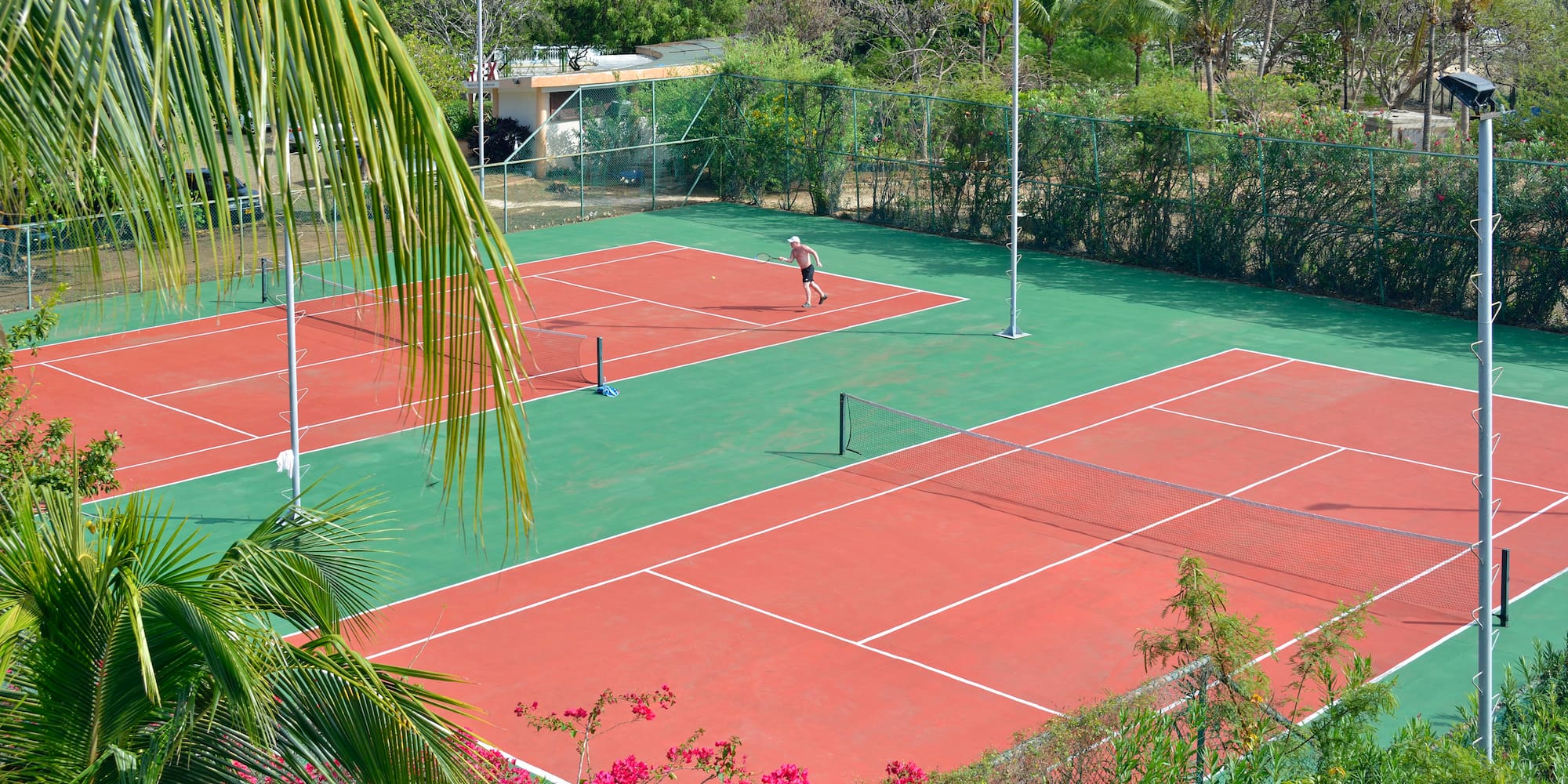 a tennis court with a person on the court
